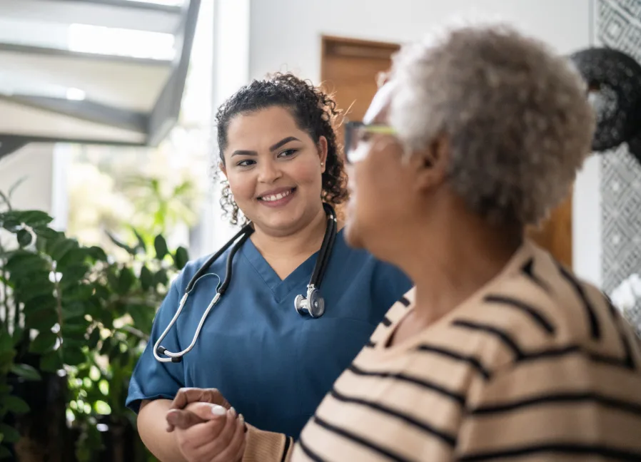 Caring nurse with resident at Gables of Ojai
