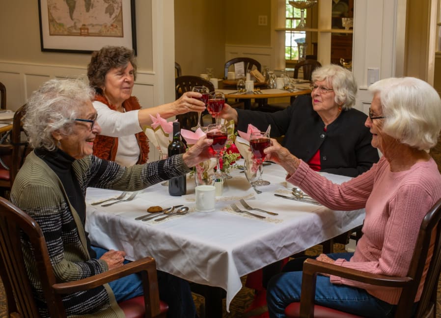 Residents enjoying a celebratory toast in the dining room