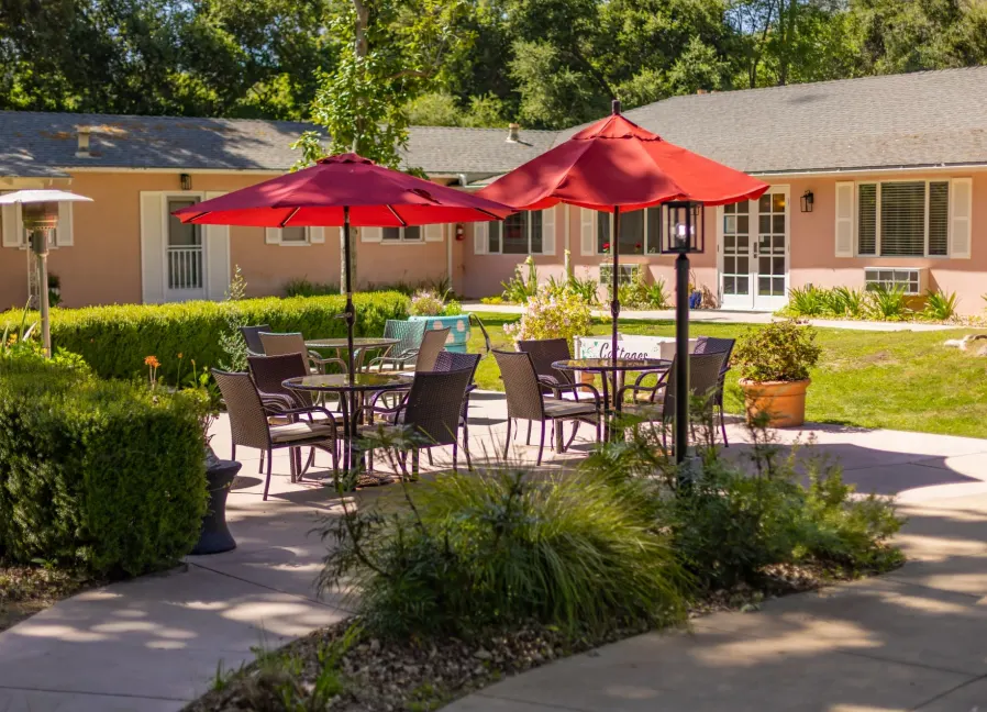 Outdoor patio seating area with red umbrellas