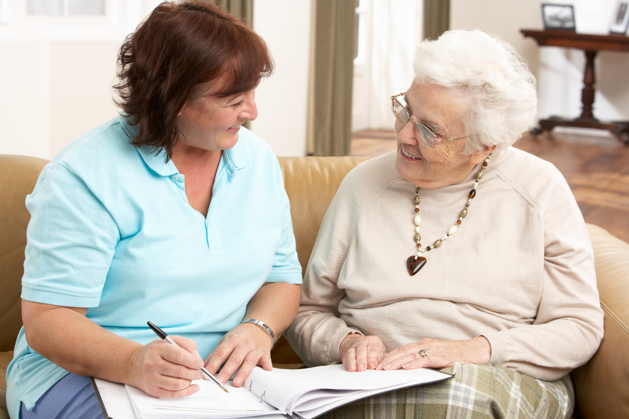 Caring caregiver with senior resident living with dementia at Gables of Ojai